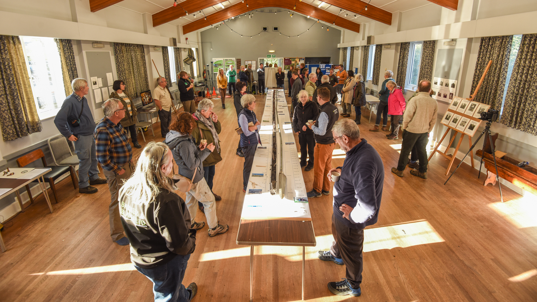 People in a village hall with a long table in the middle
