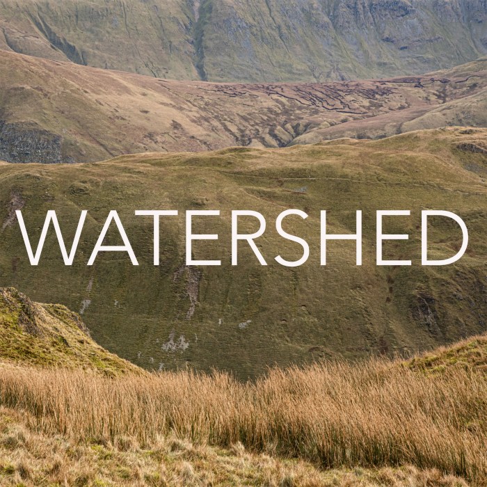 An image of hills with the word WATERSHED