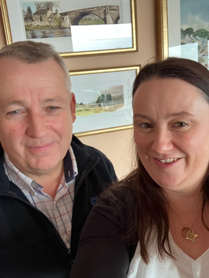 An image of a man and a woman smiling at the camera